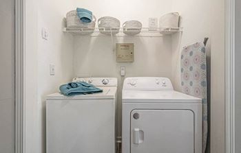 A white washing machine and dryer in a small laundry room.
